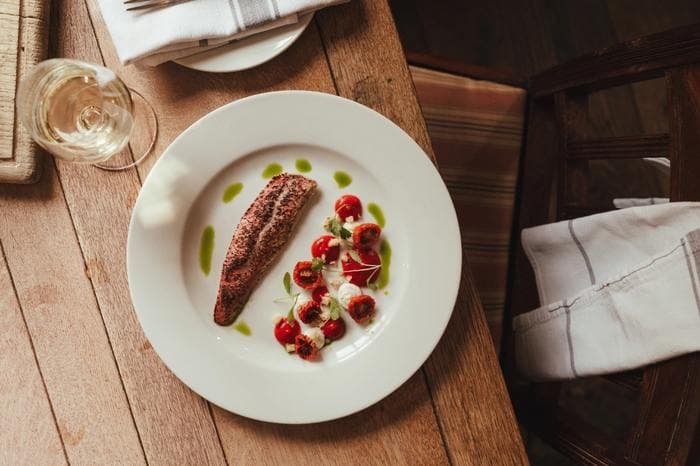 A plated main course on a wooden table