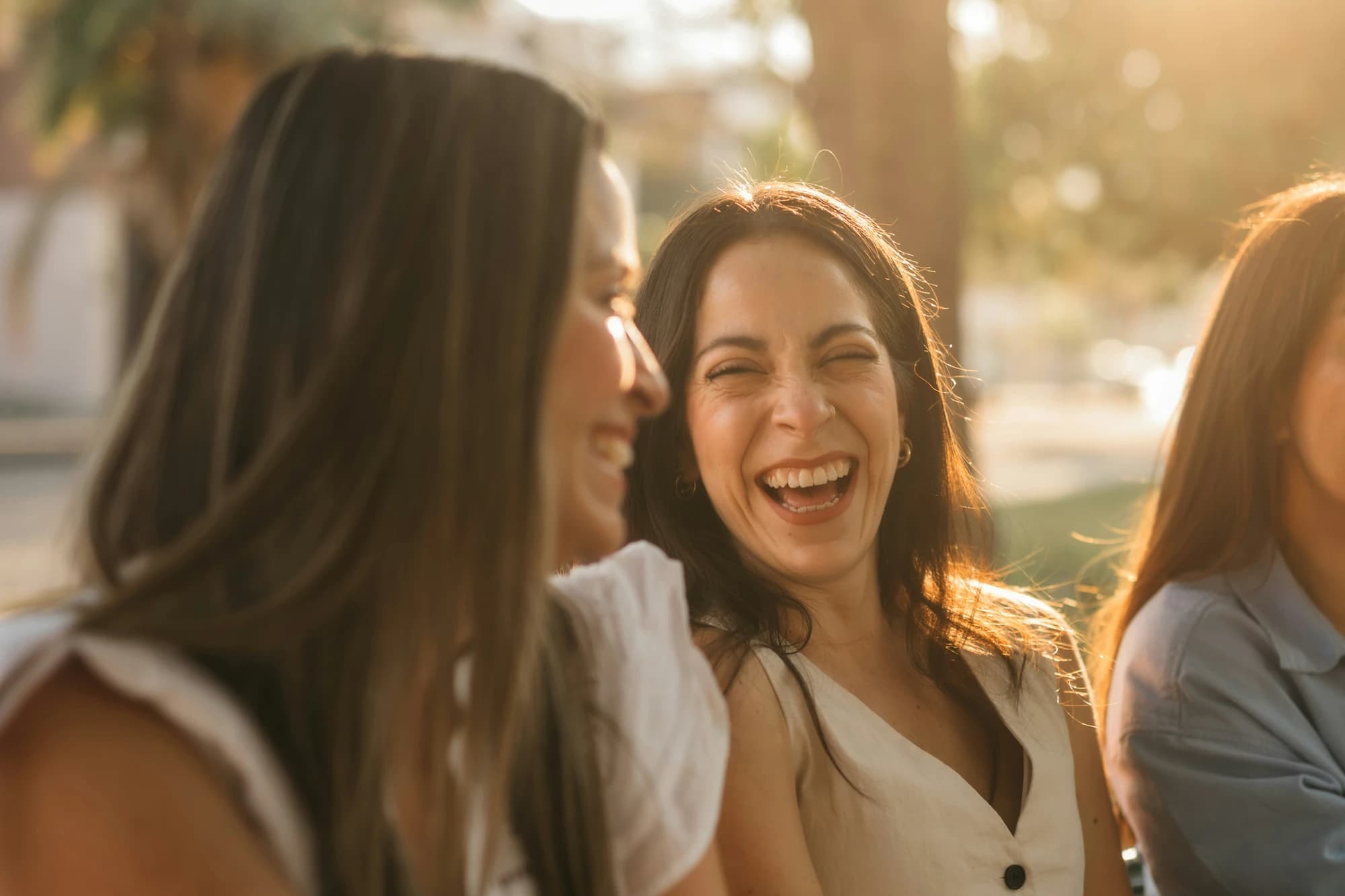 Group of friends smiling and laughing together outdoors