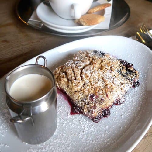 Fruit crumble served with a jug of custard