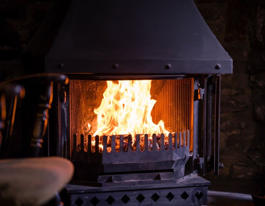 A log fire burning in the pub's stone fireplace