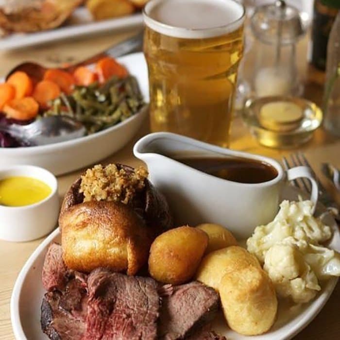 Roast beef with Yorkshire pudding, roast potatoes, vegetables and gravy