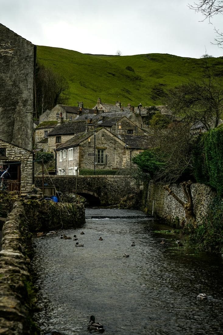 A stream running between old stone walls and cottages