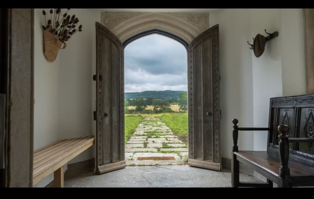 The Hermitage doors open onto the path and the fields beyond